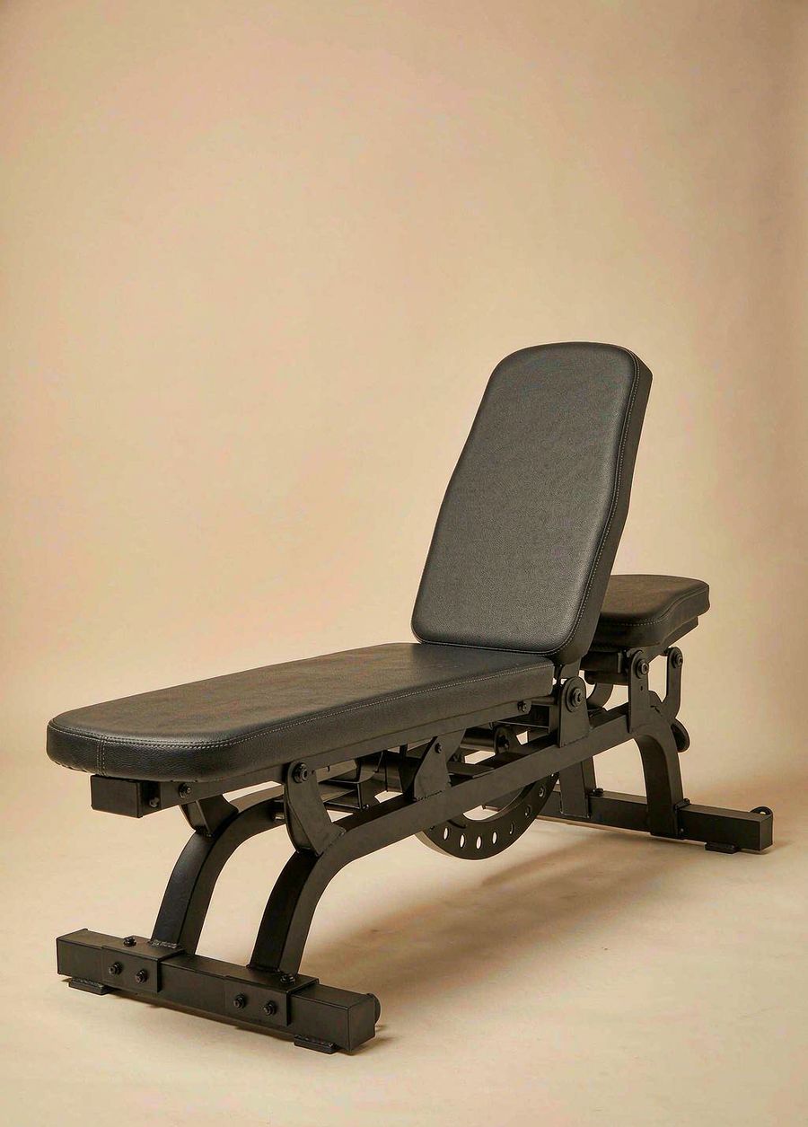 Xiaole XB-1 adjustable weight bench with black steel frame and charcoal pad on a bone background.