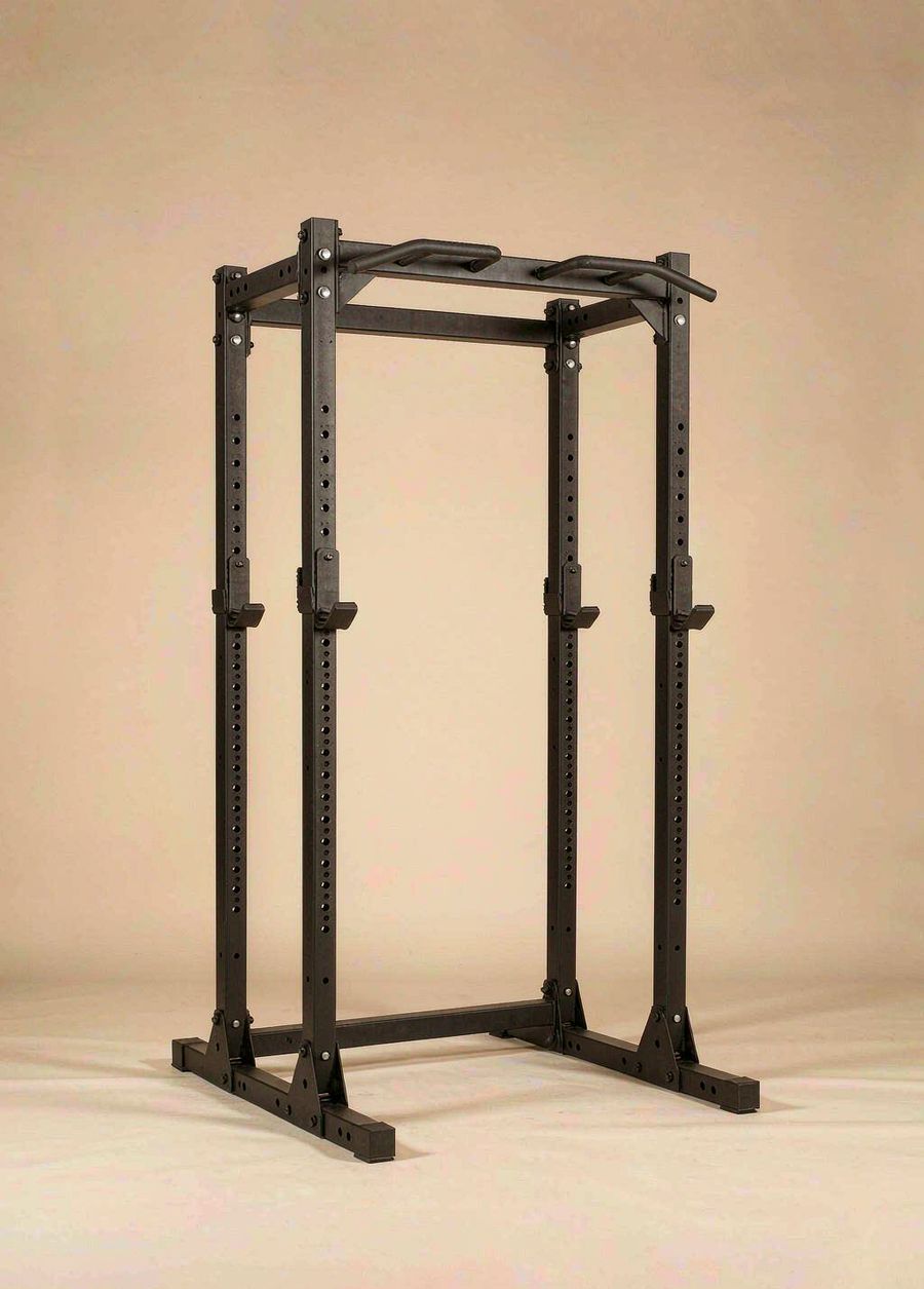 Matte black Xiaole four-post power rack with a pull-up bar, photographed against a warm bone background.